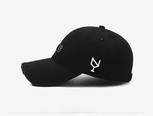 Side view of black distressed baseball cap with vintage frayed brim and white embroidery