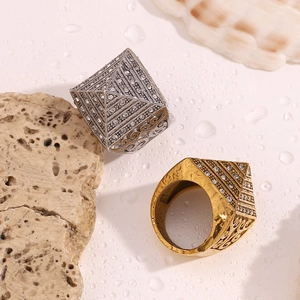 Detailed macro of pyramid rings with pavé diamonds and vintage vine leaf engravings