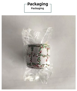 Close-up of Christmas plaid ribbon roll with red berry print in clear plastic packaging