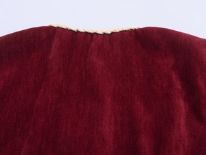 Detail of burgundy chenille fabric with premium gold braided trim on the neckline