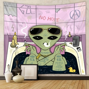 Detail of wall tapestry featuring smoking alien tattoo art in a modern room setup