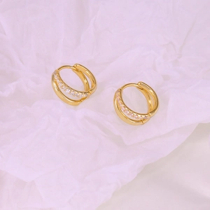 Macro detail of S925 sterling silver double-layer gold hoop earrings with zircon stones