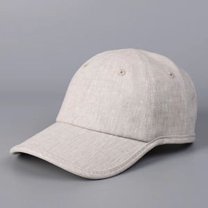 Detail of light beige breathable linen baseball cap showing fiber texture and eyelets