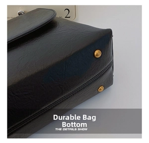 Macro shot of wear-resistant black leather bag bottom with gold metal protective studs