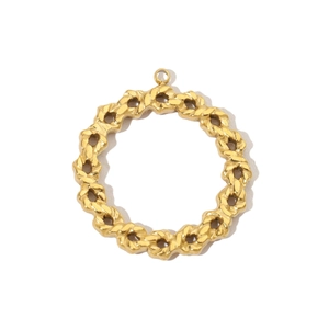 Detail of a golden round jewelry pendant with intricate woven chain texture on white background