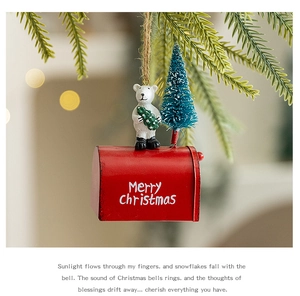 Detail of red Christmas mailbox ornament with white polar bear and snowy pine tree