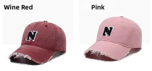Close-up of distressed brim details and letter N embroidery on vintage cotton baseball caps