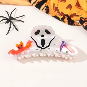 Detailed view of pearlescent Halloween ghost hair claw with bat and purple scythe accents