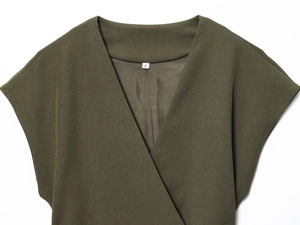 Detail of army green V-neck wrap top showing fabric texture and S size label