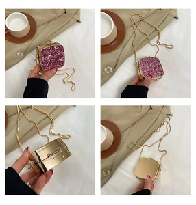 Macro view of mini acrylic evening bag with pink sequins and gold metal frame details
