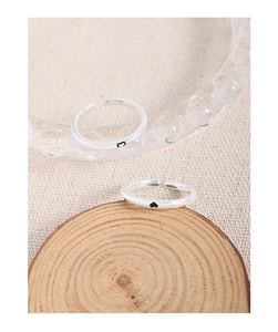 Detail of S925 silver adjustable open rings with black heart accents on wooden display