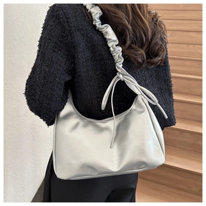 Chic silver shoulder bag with pleated cloud strap and delicate ribbon bow detail