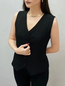 Close-up of black V-neck slim-fit vest with three-button closure and professional tailoring