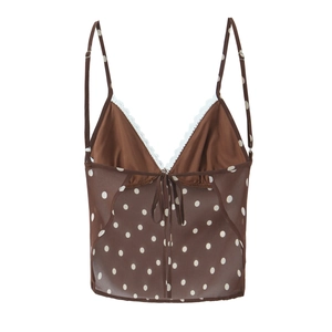 Close-up of brown polka dot mesh camisole with white lace trim and front bow detail