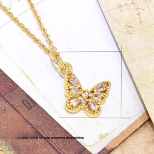 Detail of 18k gold plated butterfly pendant necklace with cubic zirconia inlay