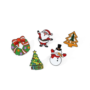 Detailed close-up of 5-piece Christmas enamel pins including Santa, snowman and tree