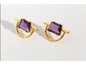 Close-up of geometric gold-plated earrings featuring purple zircon rectangle stones