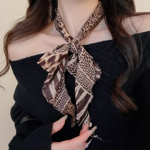 Detail of leopard print chiffon neck scarf necklace with resin link on a model