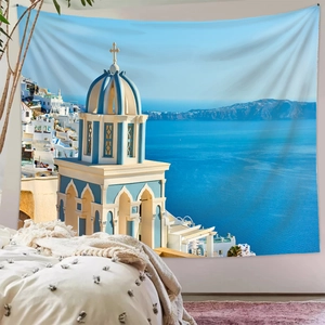 Detail view of Santorini wall tapestry hanging over a bed in a cozy bedroom