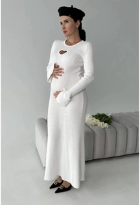 Detail of white knitted maxi dress featuring heart-shaped cutout and flared sleeves