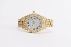 Detailed macro view of luxury gold watch dial with Roman numerals and calendar display