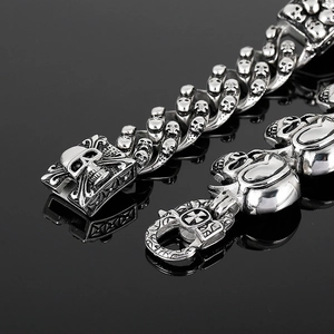 Macro shot of silver skull link bracelet showing intricate gothic metal craftsmanship