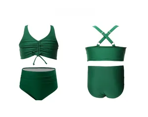 Front and back view of girls' dark green two-piece swimsuit with ruched details
