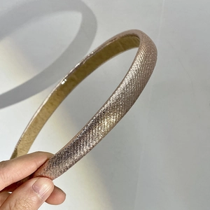 Sparkly retro candy-colored thin headband in golden brown with a glitter fabric finish
