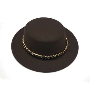 Close-up of a dark brown flat top fedora with a decorative gold chain link band detail