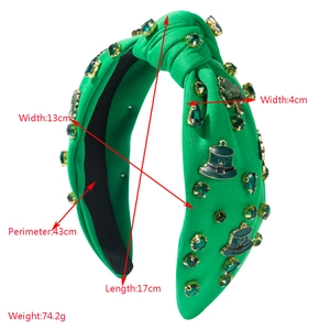 Detail of St. Patrick's Day headband showing green rhinestones and Irish clover charms