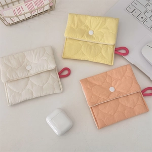Macro detail of quilted cotton mini pouches with heart patterns and snap button closures