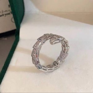 Macro detail of elegant silver-tone snake-shaped open ring with pavé zircon stones