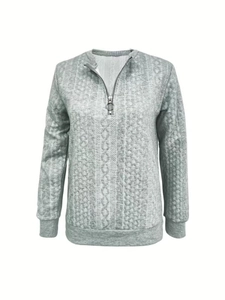 Detail of grey half-zip sweatshirt featuring a textured diamond cable knit pattern fabric
