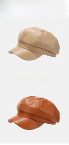 Detail of PU leather octagonal hats in khaki and caramel colors with stitching details