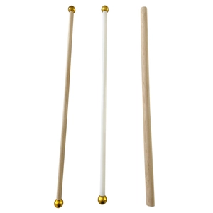 Detail of wooden hanging rods with elegant gold spherical end caps and natural finish