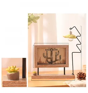 Detail of a 6-inch rotating wooden photo frame with cactus design and built-in lamp
