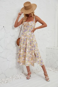 Detail of yellow floral summer dress with side slit and drawstring chest for beach holidays