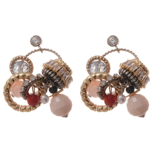 Bohemian vintage gold earrings with zircon, resin beads and pearls on white background