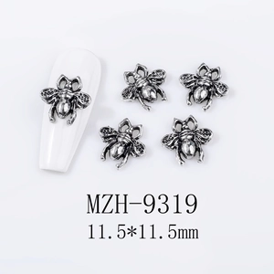 Detail view of vintage bee nail charms 11.5mm made of retro silver alloy with embossed texture