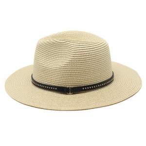 Detailed macro view of straw hat with classic black leather band and metal rivet accents