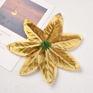 Detailed view of golden fabric poinsettia artificial flower for Christmas tree decorations