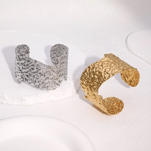 Bracelets joncs ouverts modernes martelés en or 18k et argent sur socle en pierre