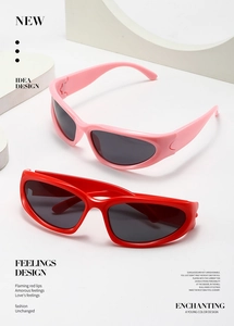Detail of pink and red Y2K wrap-around sunglasses with a sleek futuristic oval frame