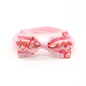 Close-up of pink Valentine's Day dog bow tie with red hearts and themed printing
