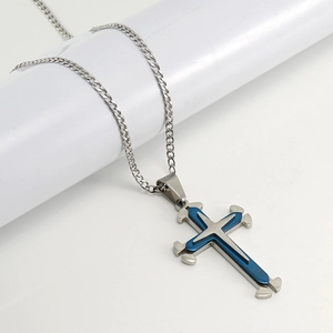 Macro shot of silver and blue double-layer cross pendant on high-quality Cuban chain
