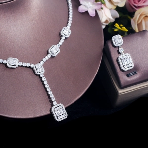 Macro detail of sparkling zircon wedding jewelry set with silver necklace and earrings