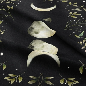 Detailed close-up of bohemian moon phase tapestry fabric texture and floral printing