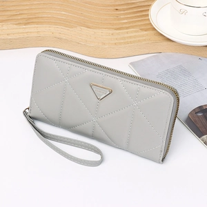 Detail of gray long wallet with quilted geometric pattern and gold FASHION logo plaque