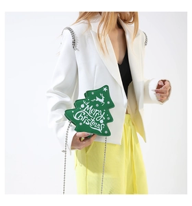 Detail of green Christmas tree shaped crossbody bag with silver ball chain and reindeer print