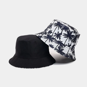 Close-up of double-sided bucket hat featuring palm tree print and reinforced stitching